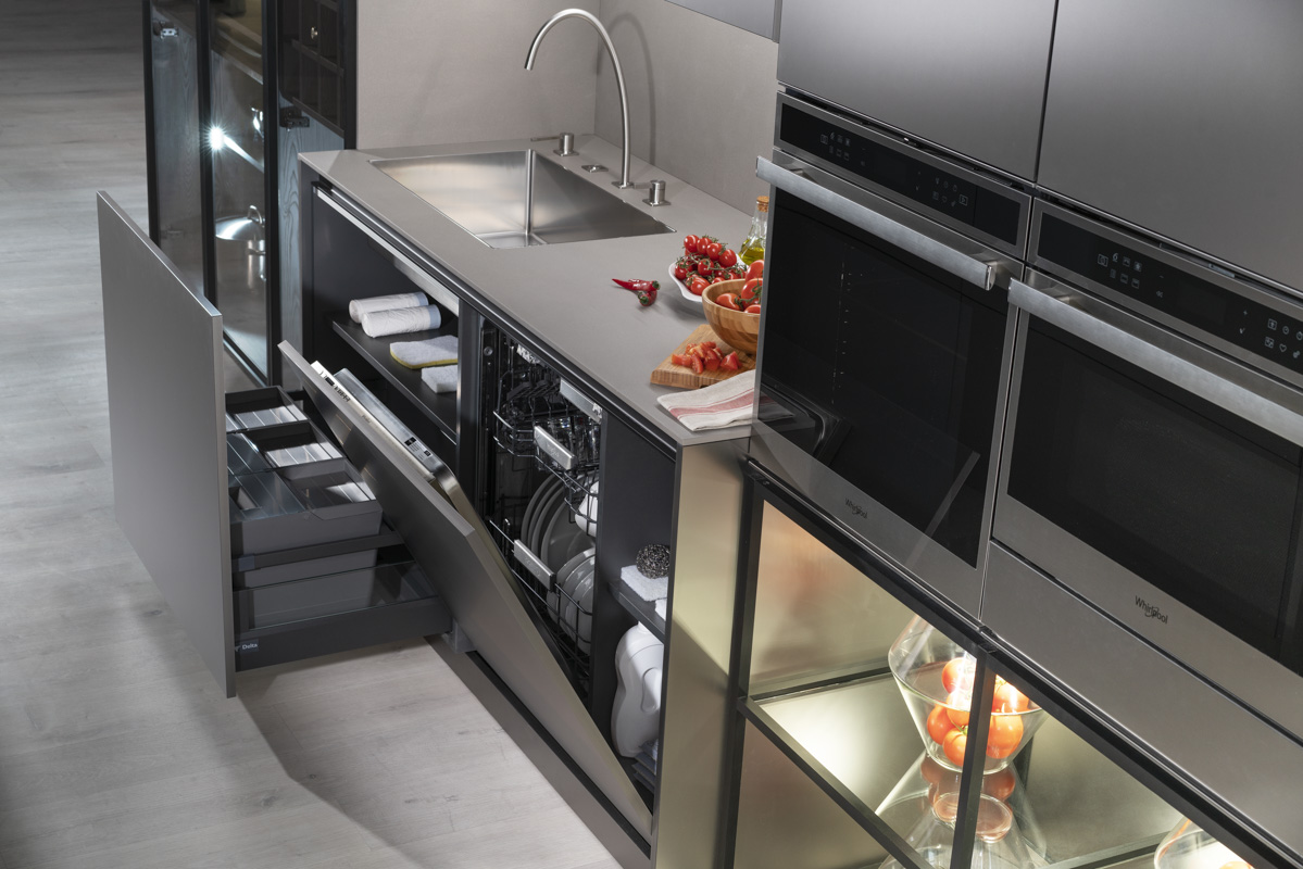 Módulo de fregadero con lavavajillas integrado y cajones organizadores ocultos. Superficie de acero inoxidable que aporta continuidad visual y practicidad. Todo se alinea en un diseño elegante y altamente funcional.